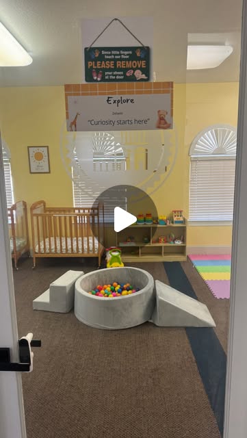 First Achievers infant room with a soft play area and classroom materials