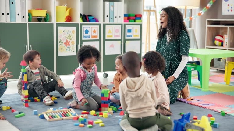A teacher guiding a group of children during classroom play
